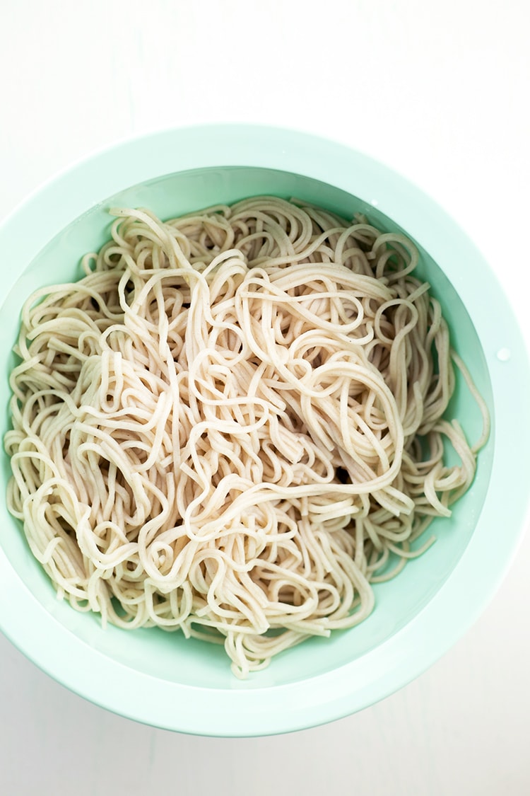 Japanese inspired Soba Noodles with edamame, carrot and cucumber - tossed in a delicious Miso Tahini Dressing. Vegan and Gluten Free. #vegan #japanese #asian #soba #healthy #foodporn #tahini #ginger #noodles